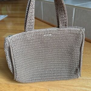 The Sak small crochet hand bag in a neutral color.